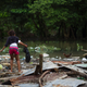 Picture taken in the flooded neighbourhood of La Puya, in Santo Domingo on October 4, 2016 after the passage of Hurricane Matthew through Hispaniola — the island that the Dominican Republic shares with Haiti. Matthew, a Category Four hurricane, slammed into the Dominican Republic and Haiti Tuesday, triggering major floods and forcing thousands to flee the path of the storm that has claimed at least three lives in each country. (Image: Getty)